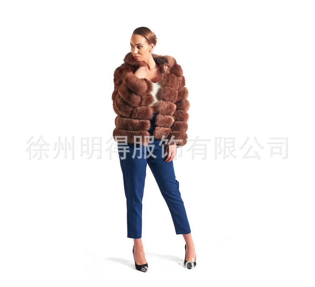 A woman modelling a loose-fitting, hooded artificial fur coat in a street fashion style.