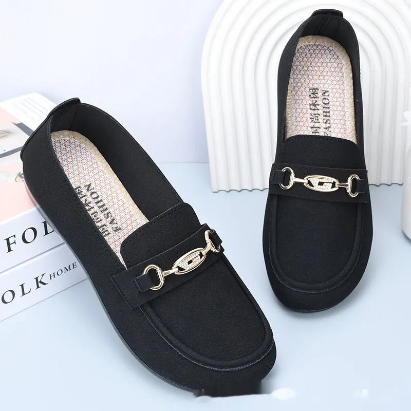 Gommino women's black slip-on casual shoes with a round toe and soft rubber sole on a neutral background.