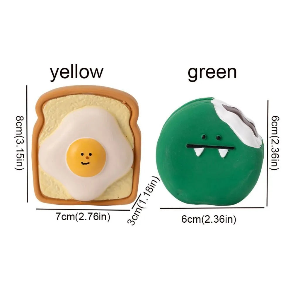 Green and yellow latex dog chew toy shaped like cartoon egg bread with a squeaker.