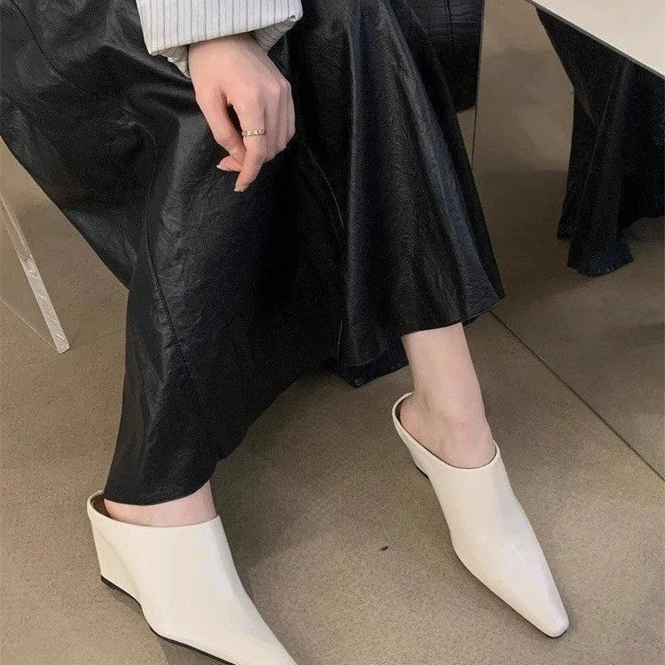 Women's black closed toe wedge half slippers showing PU upper material and wind wedge sole design