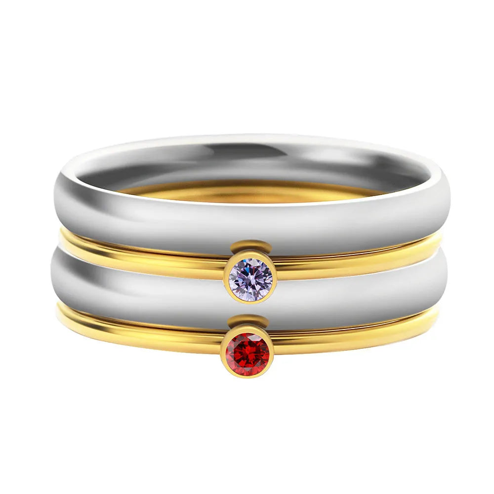 A geometric titanium steel ring with a December colour birthstone in an engraved, superimposed design.
