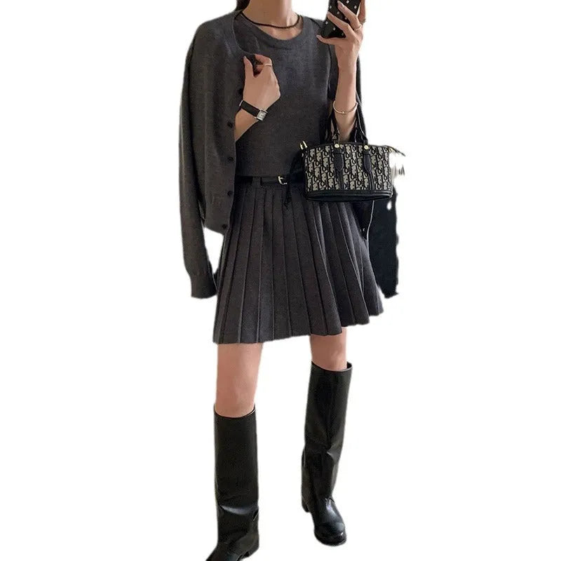 Women's grey Art Retro knitted set with 3D pattern, featuring a pleated midi skirt and long-sleeve cardigan.