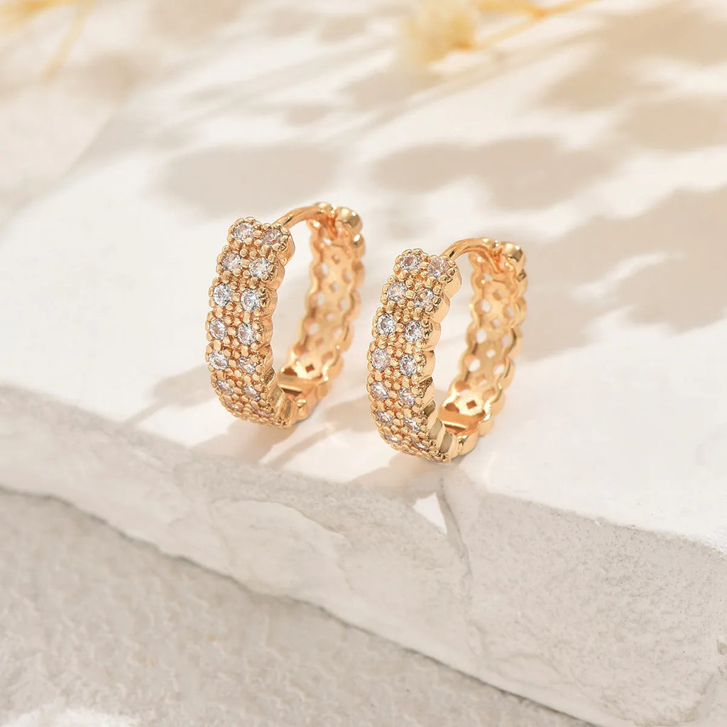 Copper geometry pattern stud earrings with round, dot, and ring details on a white background.