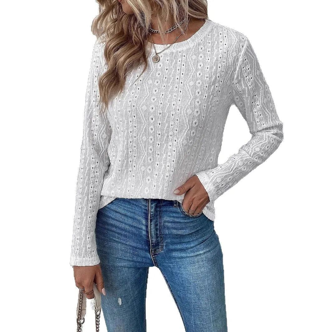 White loose fit long sleeve round neck t-shirt on a hanger.