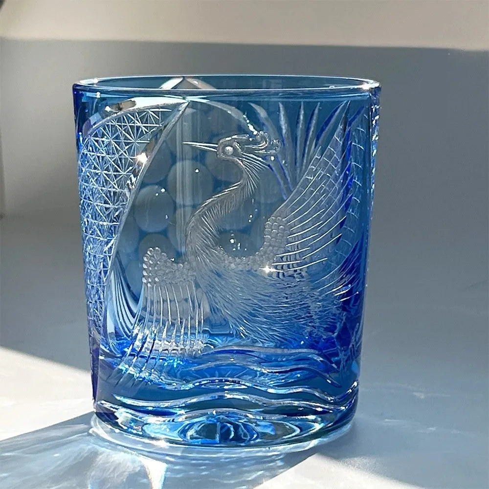 Hand carved crystal whiskey shot glass in sky blue with crane motif, 90x100mm