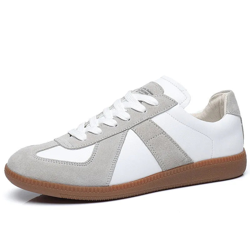 White Japanese-style retro low-top sneakers with mesh lining and a flat rubber sole on a plain background.