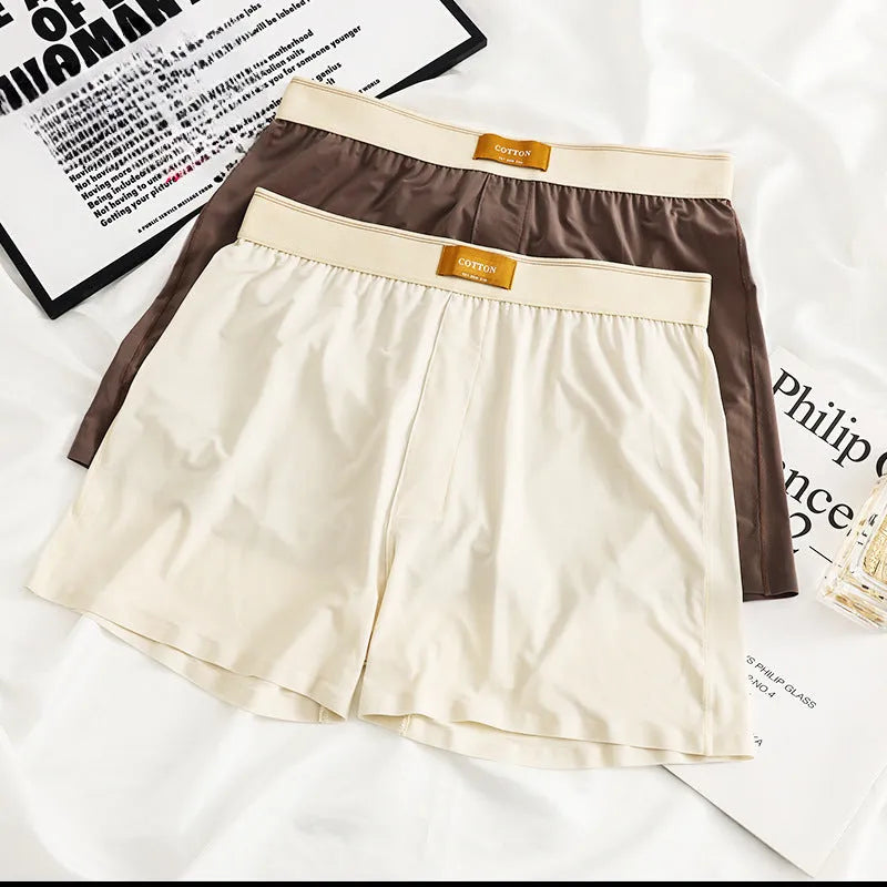 Pack of three men's solid colour loose fit ice silk nylon underwear on a mid waist mannequin.