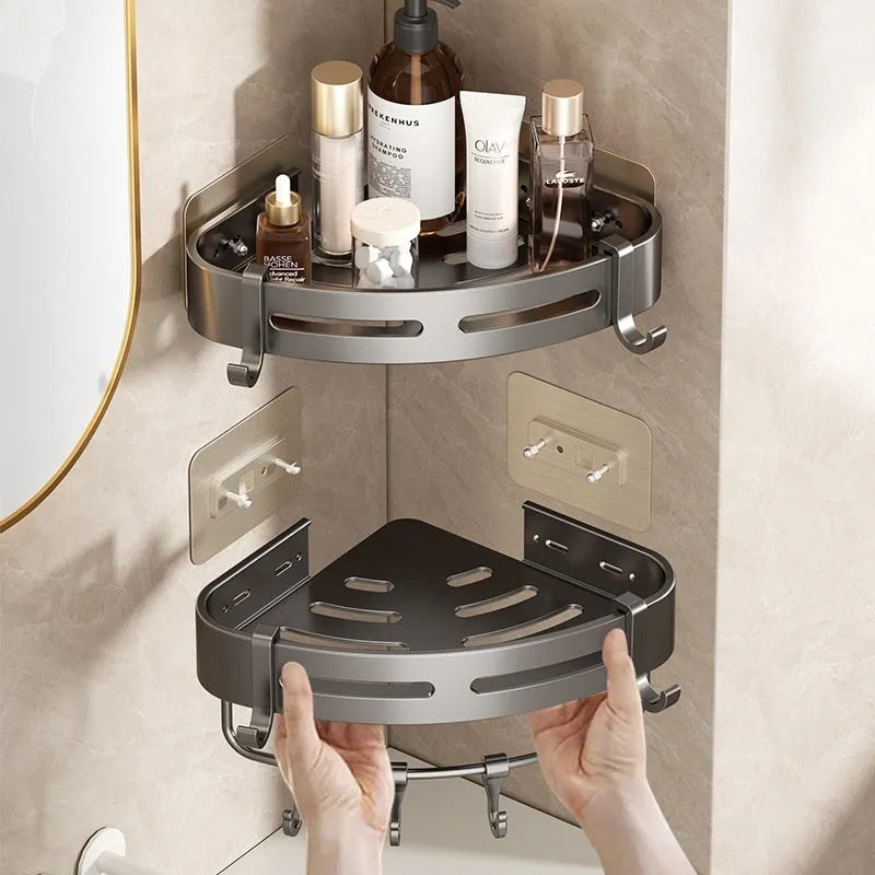 Gun Gray metal corner storage rack mounted on a bathroom wall, holding toiletries.