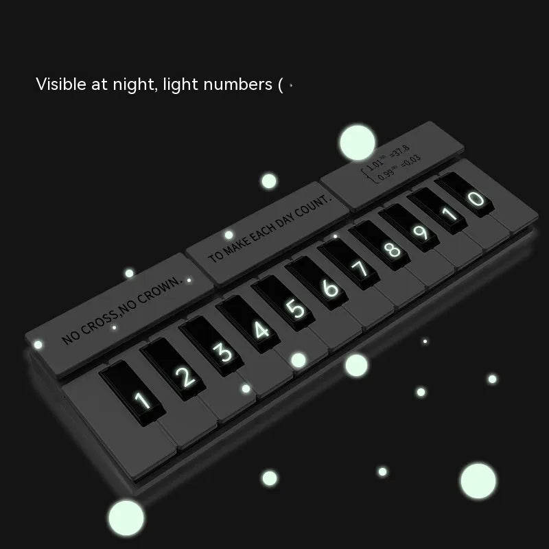 Black and white plastic piano-shaped temporary parking sign for car dashboards.