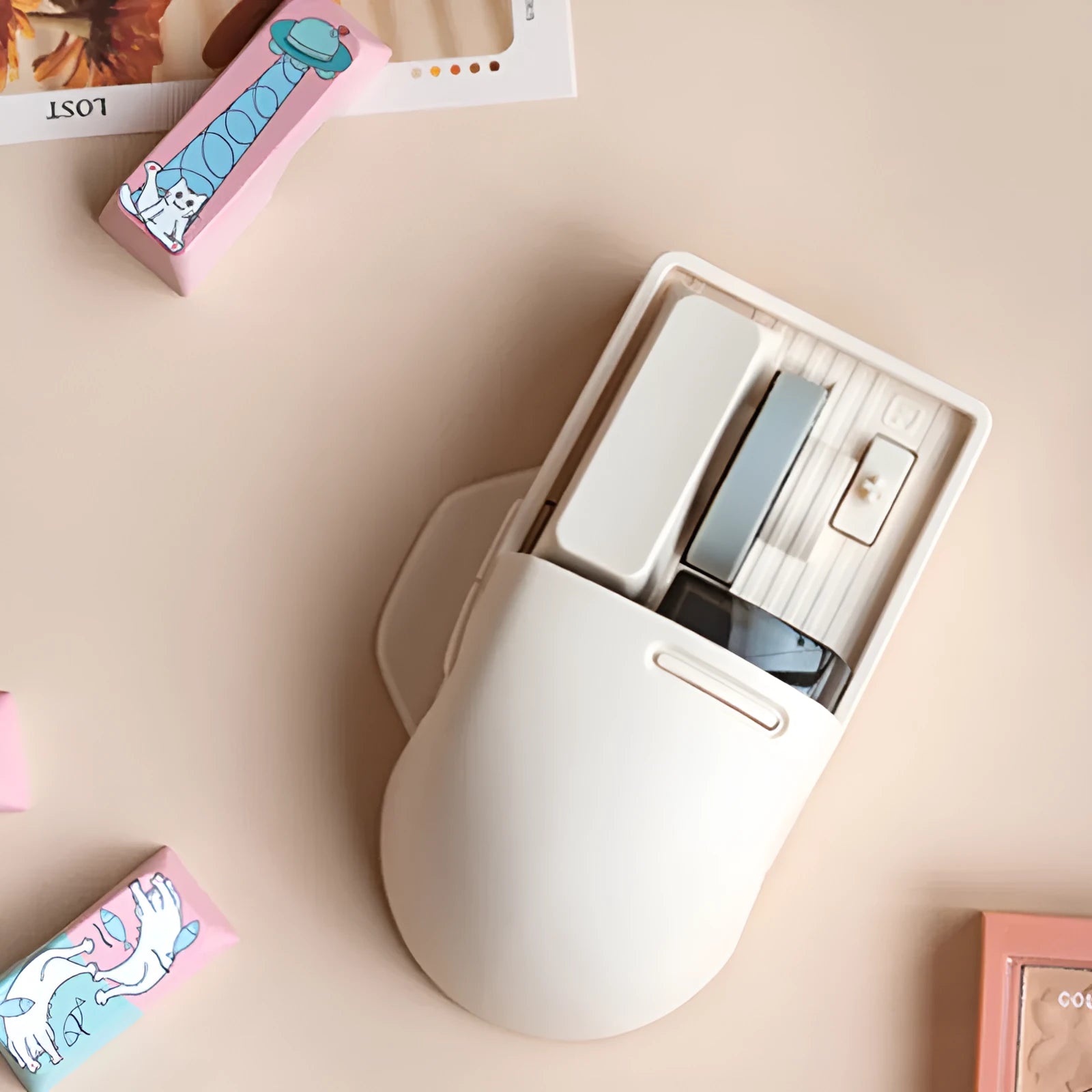 Tofu-coloured three-mode wireless mouse with ergonomic design on a desk.
