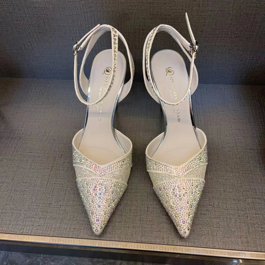 Women's silver hollow high heels with red sole and pointed stiletto heel.