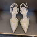 Women's silver hollow high heels with red sole and pointed stiletto heel.