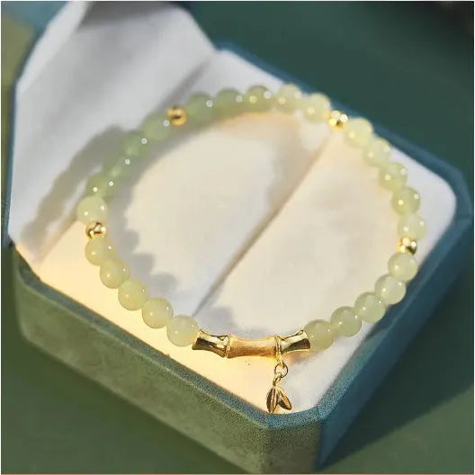 Bamboo-themed glass bracelet with coloured glaze beads and electroplated flower charm