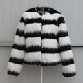 Women's long-sleeved black and white striped faux fur leather jacket on a hanger.