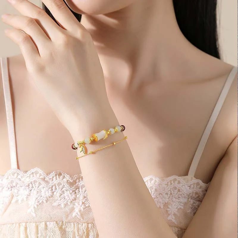 Bamboo-themed glass bracelet with coloured glaze beads and electroplated flower charm