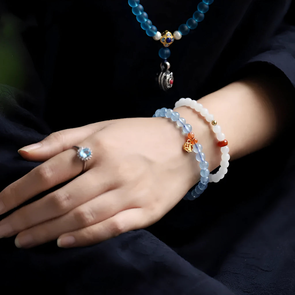 Icy translucent aquamarine crystal bead bracelet with sequin charm and blessing card.