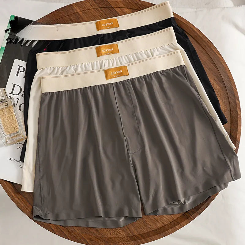 Pack of three men's solid colour loose fit ice silk nylon underwear on a mid waist mannequin.
