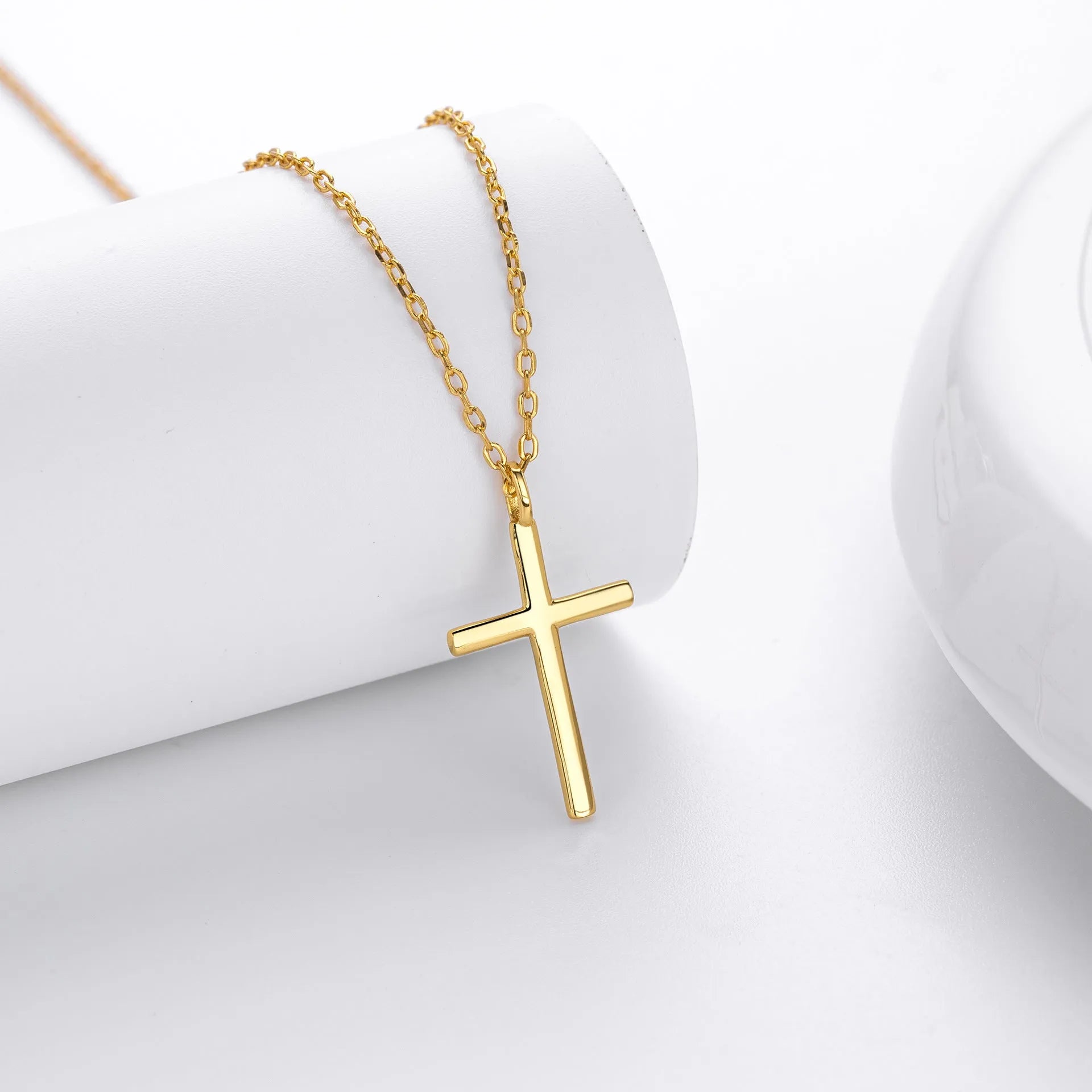 S925 sterling silver cross pendant necklace on an O-shaped chain in a gold electroplated finish.
