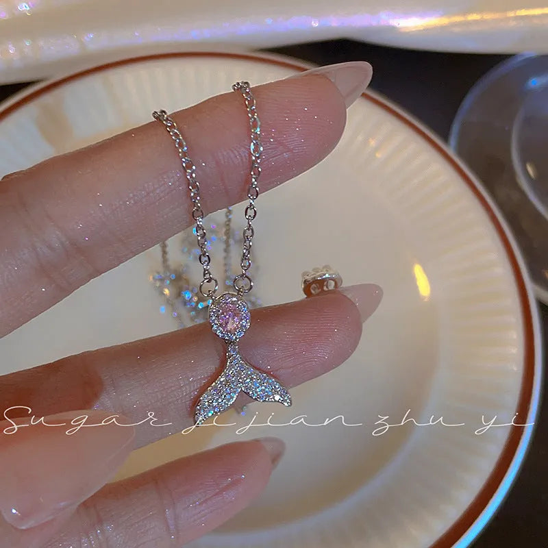 Simple sterling silver necklace with a geometric fishtail or angel wing pendant on an O-ring chain.