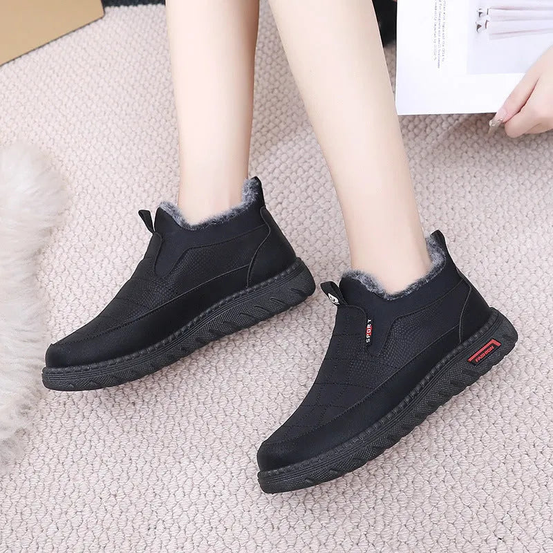 Women's black casual flat ankle boots with round toe and synthetic leather upper on a neutral background.