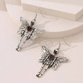 Pair of silver-coloured alloy earrings with exaggerated skull design on white background