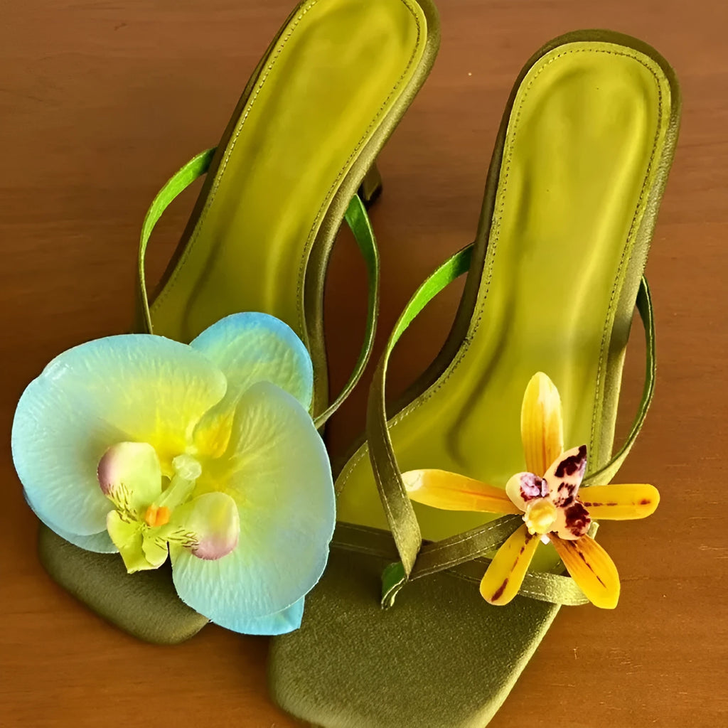 Women's handmade asymmetric flower high-heel sandals in black with a square toe and calf leather upper.