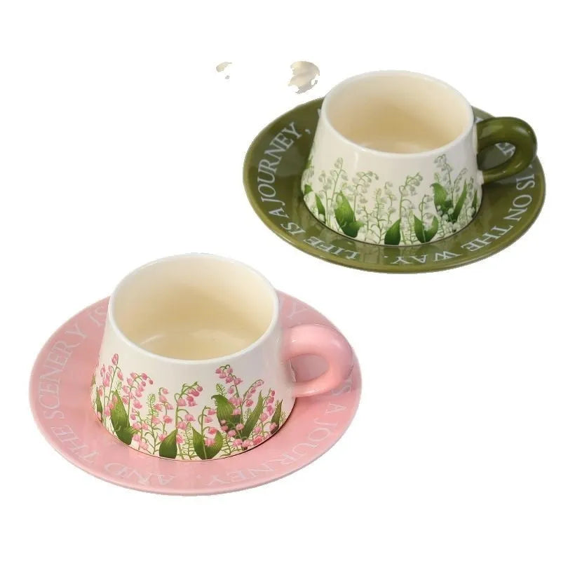 Ceramic coffee cup and saucer set with two cups, two plates, and two spoons