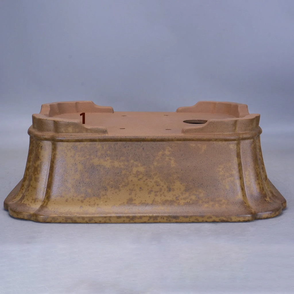 Hand-thrown rectangular purple sand flower pot with dual drainage holes on a wooden deck.