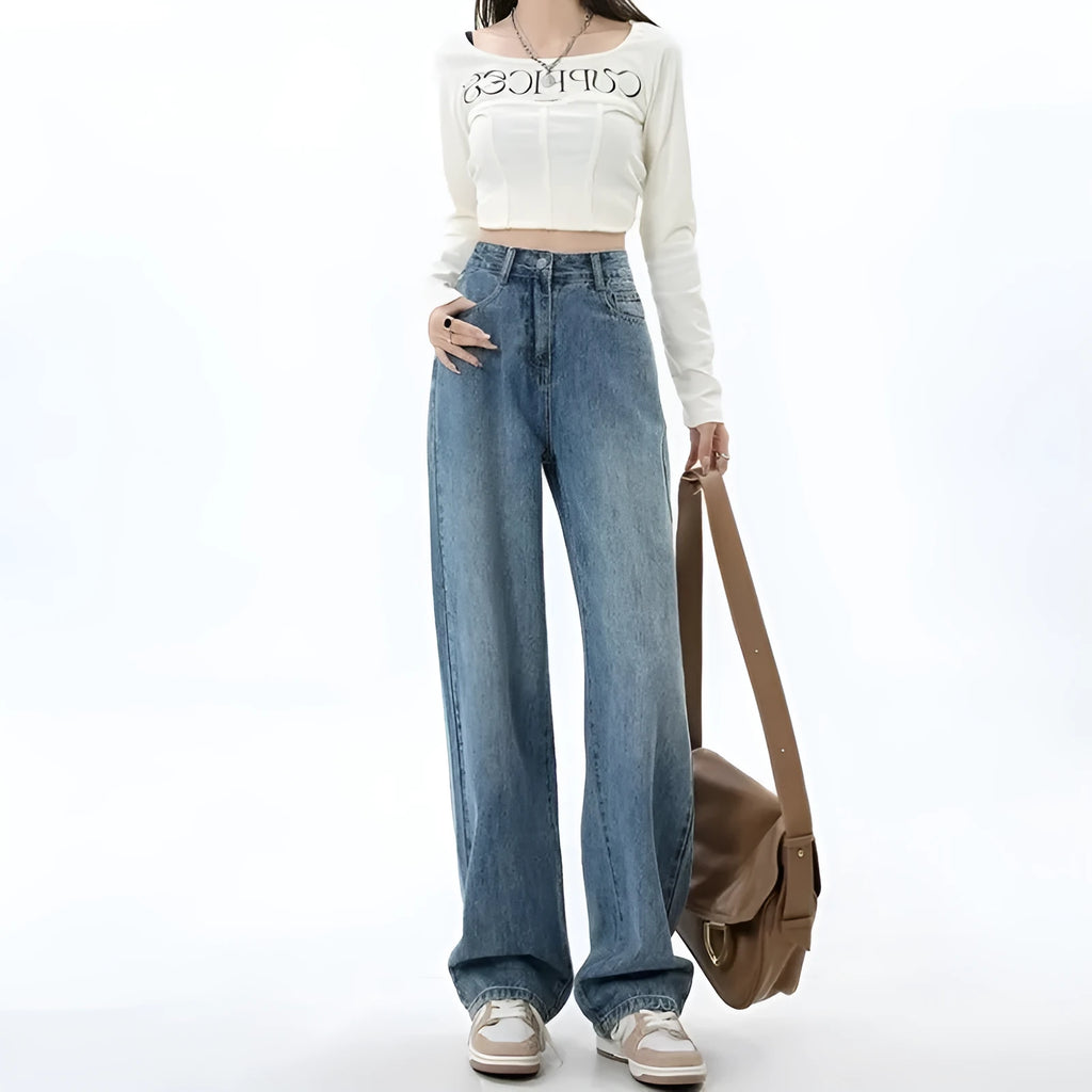Woman wearing high-waisted retro blue wide-leg denim jeans with a straight cut.