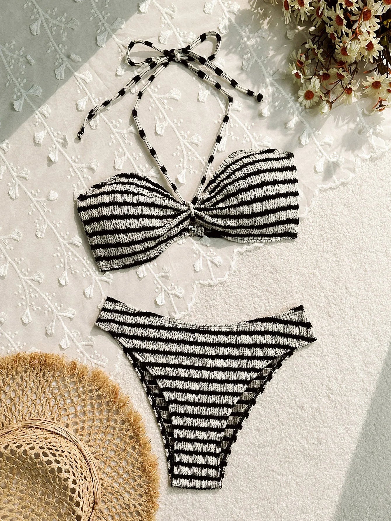 Women's pink and black striped bikini swimsuit with solid briefs.