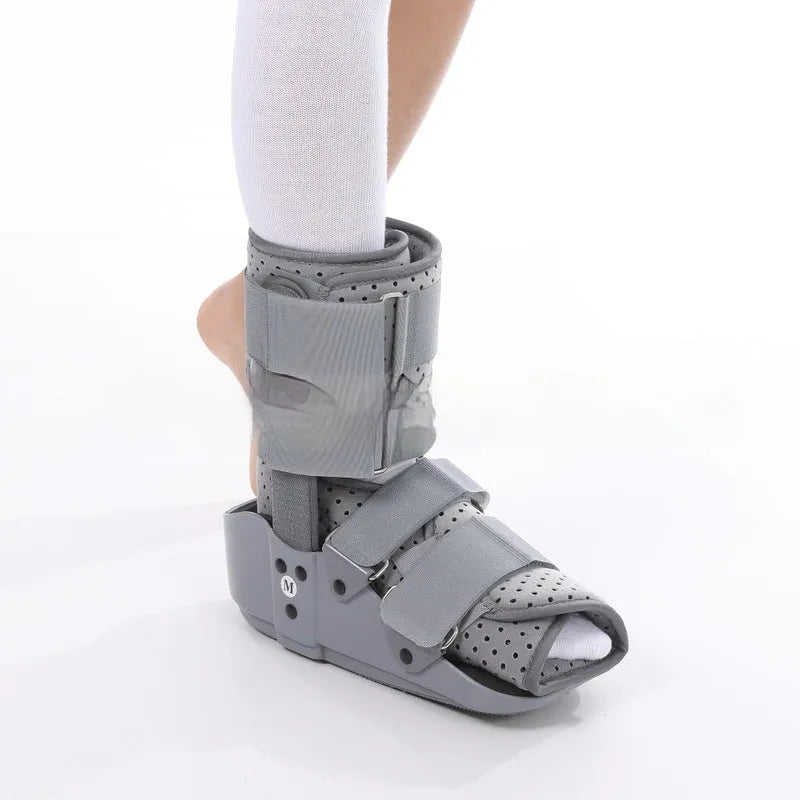 Grey Achilles tendon rehabilitation boot with fixed support and walking shoe sole.