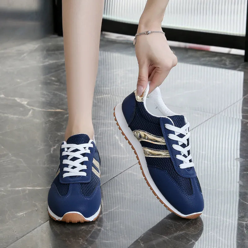 Blue women's lace-up tennis shoes with cross shoulder straps and a round toe