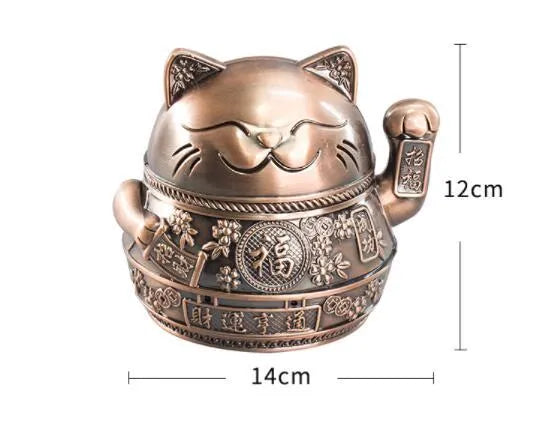 Zinc alloy lucky cat ashtray with cover in gold black colour on a wooden table