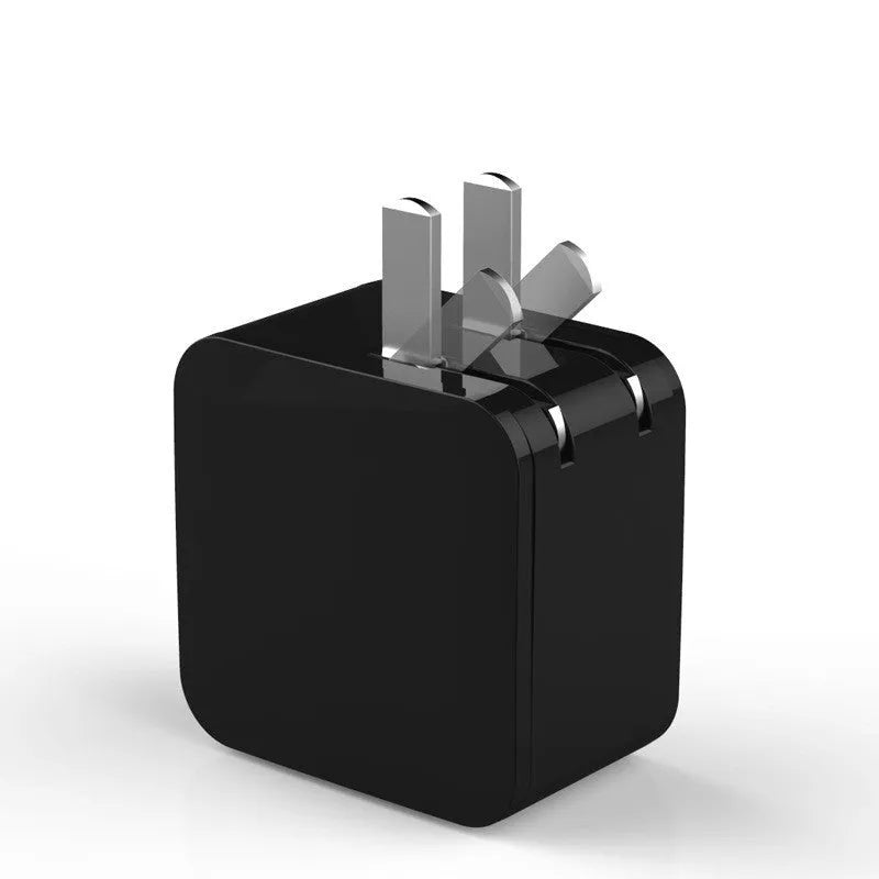 A black dual USB travel charger with a digital display showing '5V', plugged into a UK wall socket.