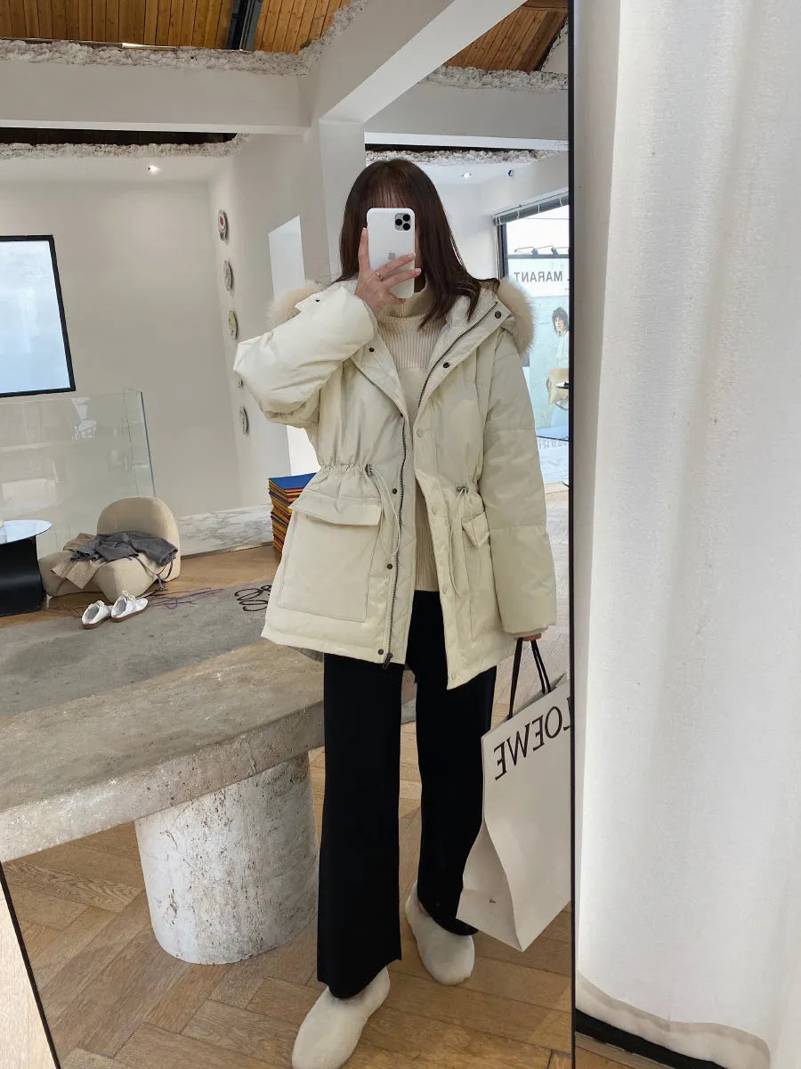 Woman wearing cream white knitted high-waist wide-leg winter trousers.
