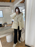 Woman wearing cream white knitted high-waist wide-leg winter trousers.
