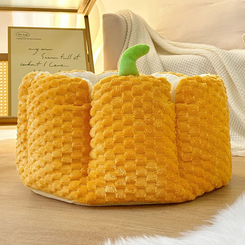 Orange pumpkin-shaped pet bed nest for cats and small dogs on a wooden floor.