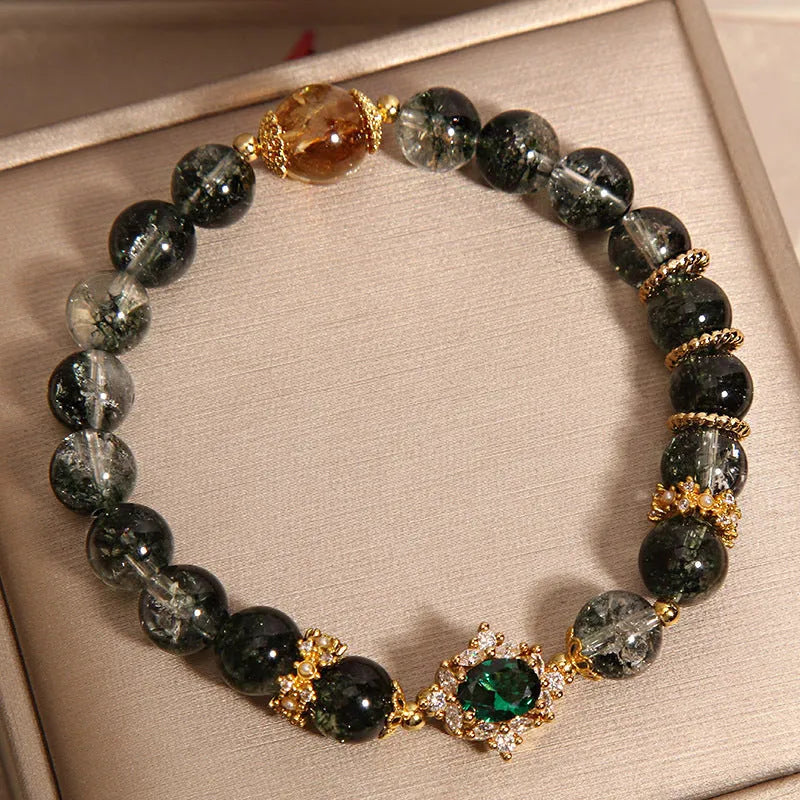Gold rutilated quartz bracelet with green phantom quartz and ruby quartz crystal beads, pearl accents, and gold-plated detailing