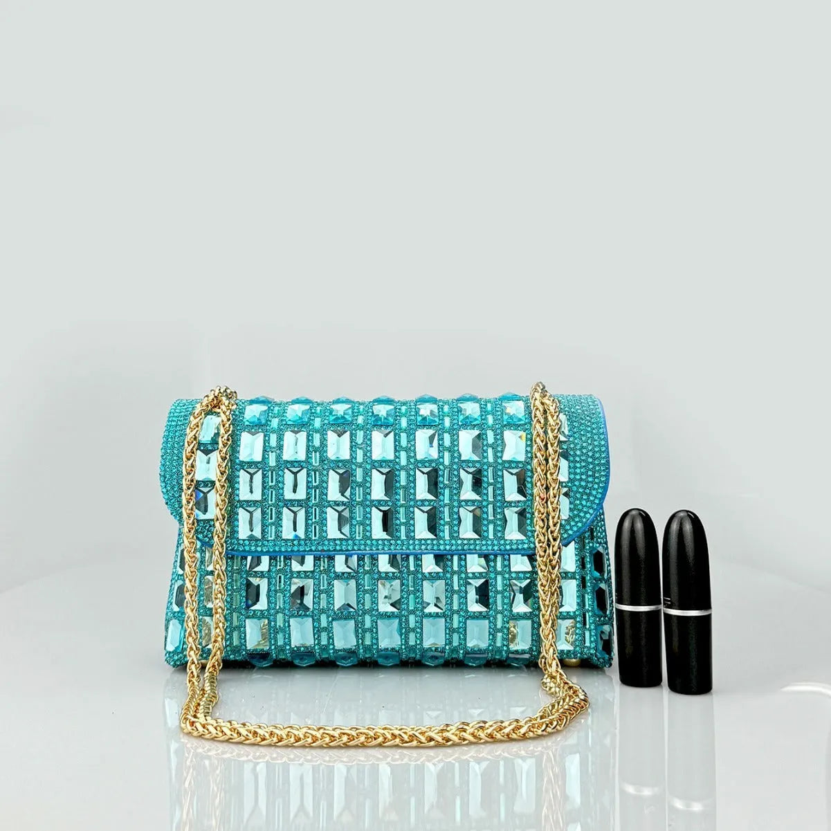 Silver rhinestone chain clutch purse with a horizontal square shape and open pocket.
