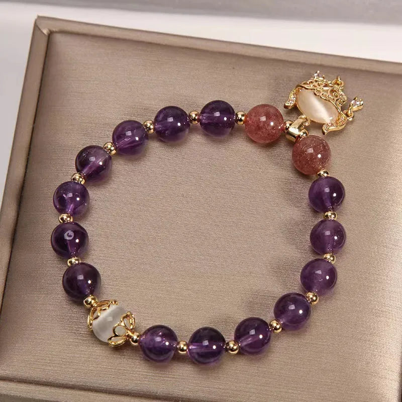 Women's copper bracelet with natural amethyst stones, gold accents, and a longevity lock charm