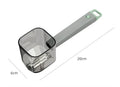 Creative green stainless steel and plastic vegetable peeler on a kitchen surface.