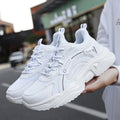 Women's white casual mesh sports shoes with round toe, buckle detail, and a thick PU sole.