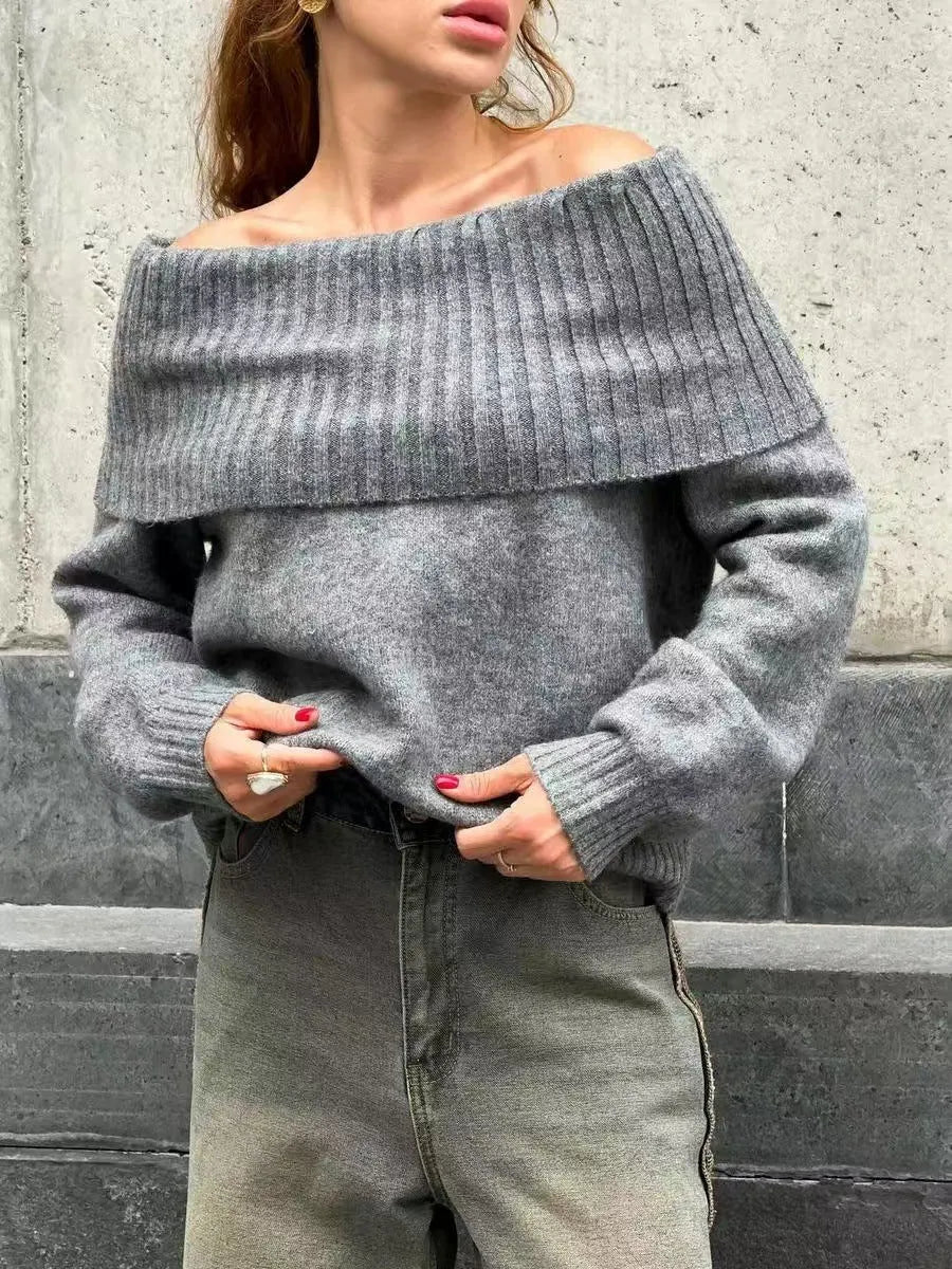 Grey off-the-shoulder sweater with a 3D pattern and strapless design on a model.
