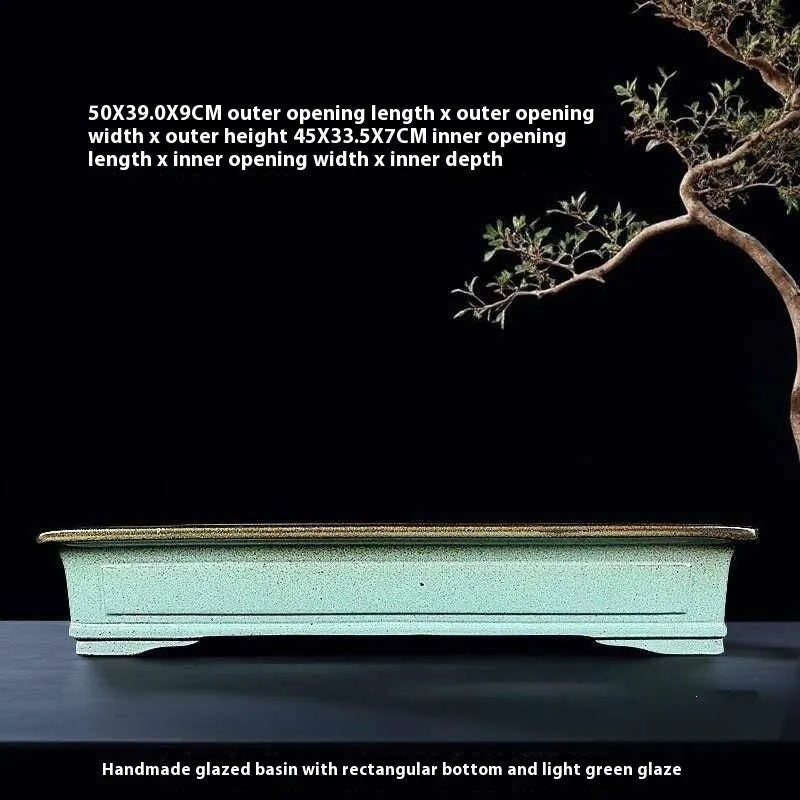 Green handmade ceramic bonsai flower pot with a retro purple sand crackled glaze.
