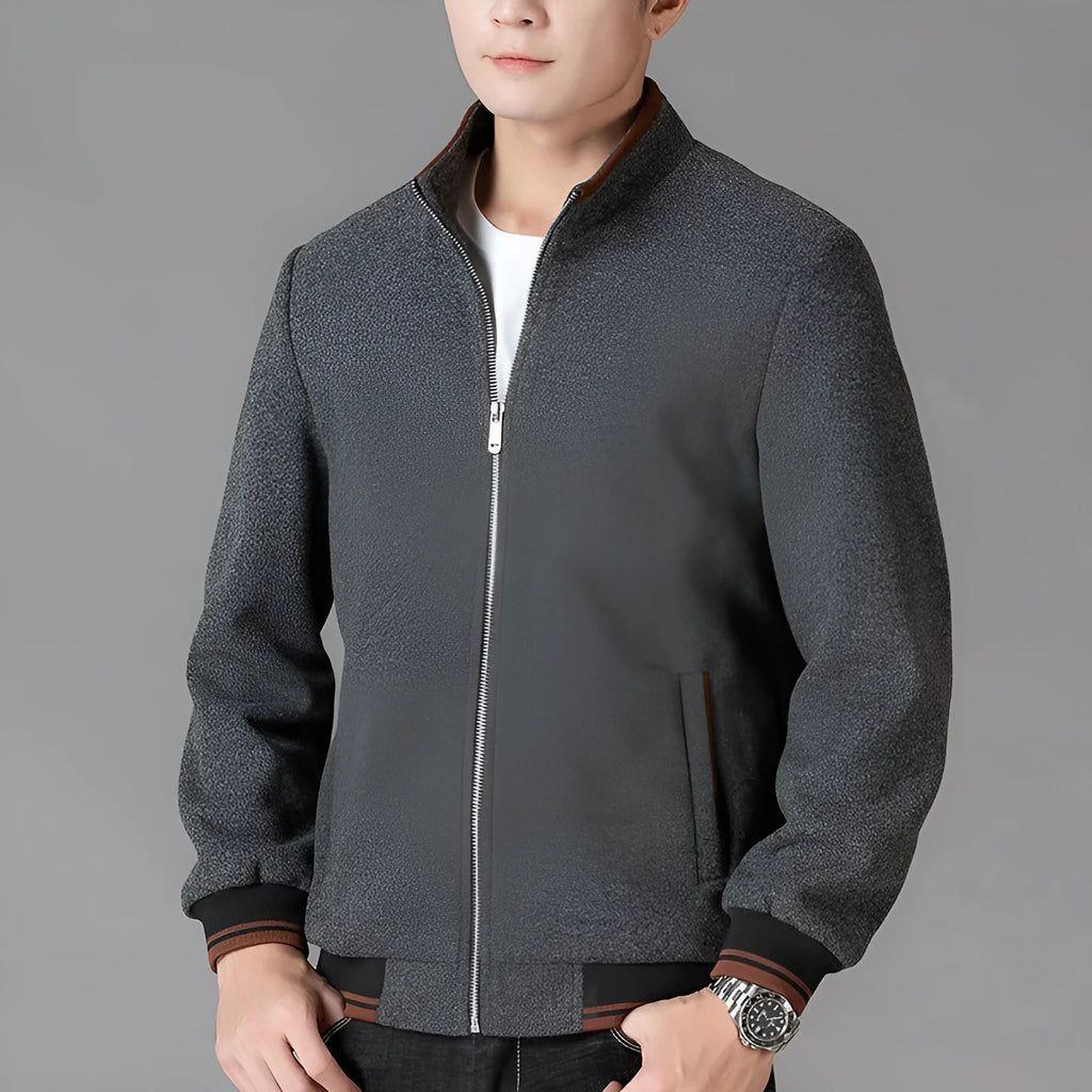 Men's grey polyester fleece sports coat with long sleeves and side pockets.