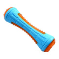 Set of four squeaky dog toys: a blue ball, a red barbell, and two orange tyres, shown on grass.