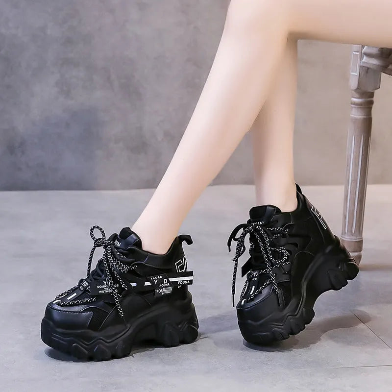 White women's breathable mesh platform trainers with a cross strap and a thick rubber wedge sole.