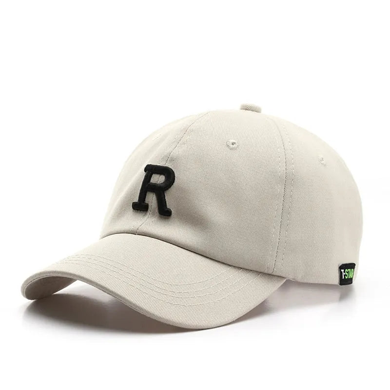 Adjustable cotton baseball cap with embroidered letter R in beige colour, dome style, unisex design
