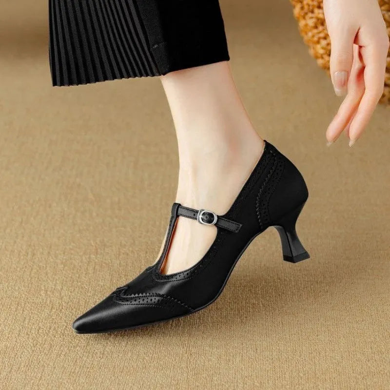 Women's black high heel pump with skull engraving and stiletto heel on white background