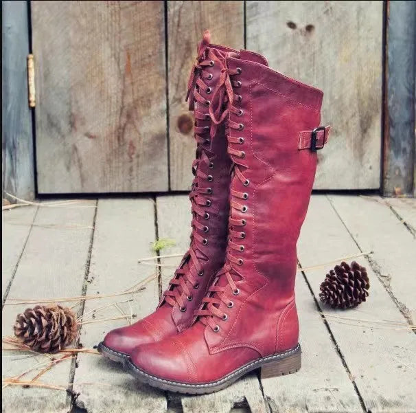Women's black chunky heel high leg boots with a round toe and pull-on design.